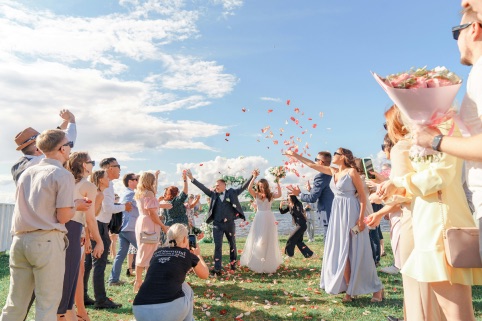 Guests raising glasses around a happy couple